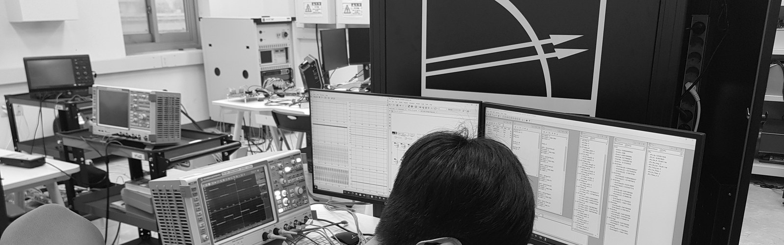 A lab member at the real-time simulation bench